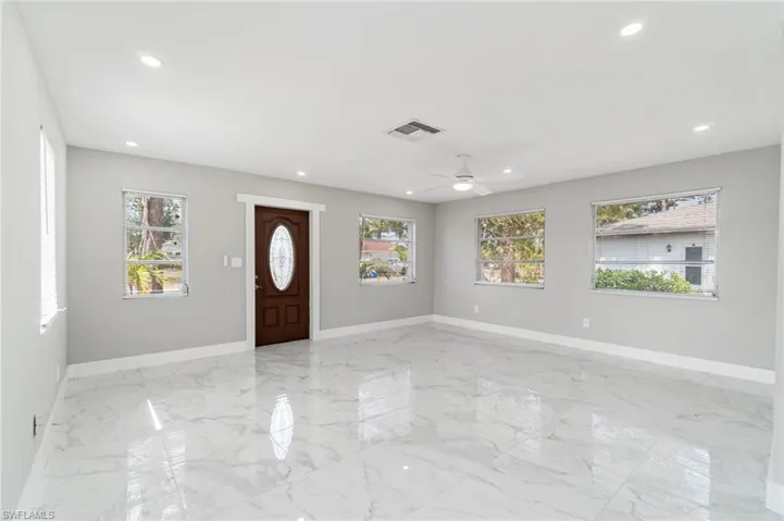 Entryway featuring baseboards, light marble finish flooring, recessed lighting, and a ceiling fan