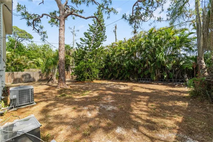Fenced backyard featuring cooling unit