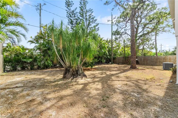 View of yard with fence and central AC unit