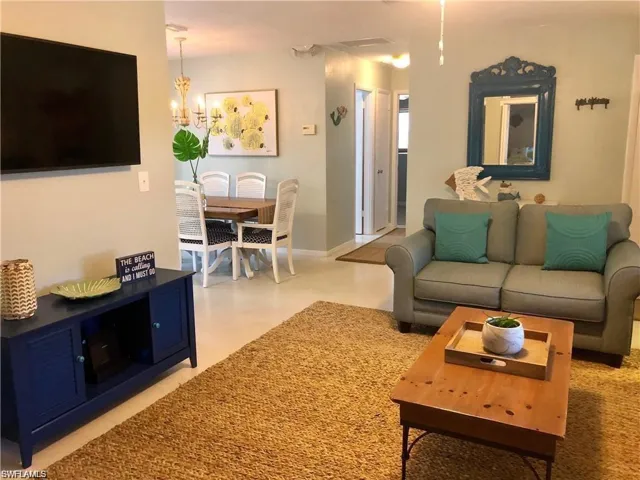 Living room with concrete flooring and a chandelier