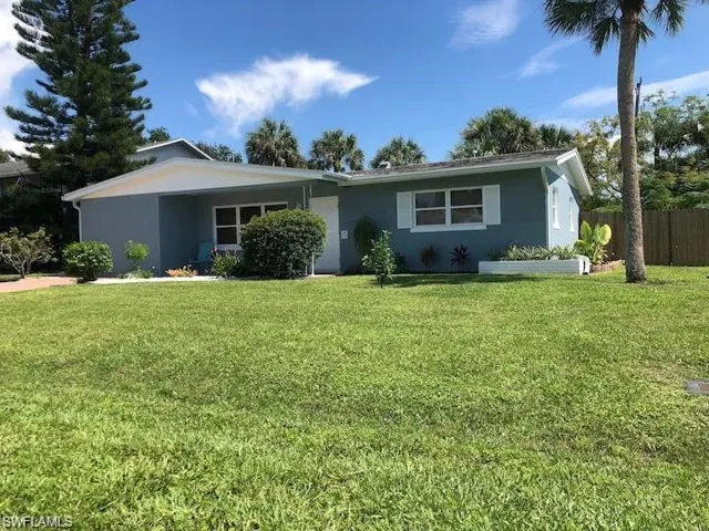 Ranch-style home with a front lawn