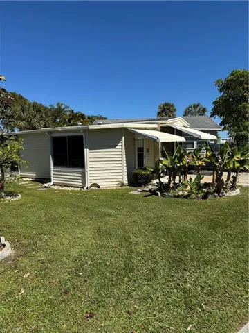 View of home's exterior with a yard