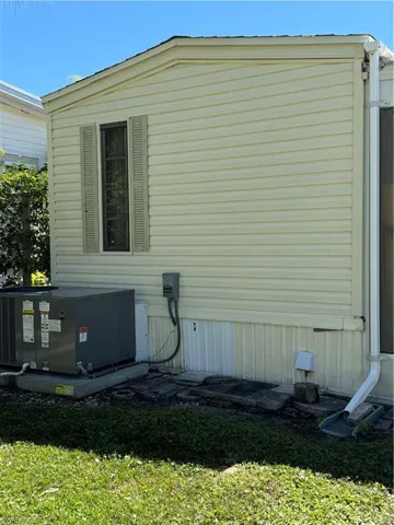 View of side of home featuring central air condition unit