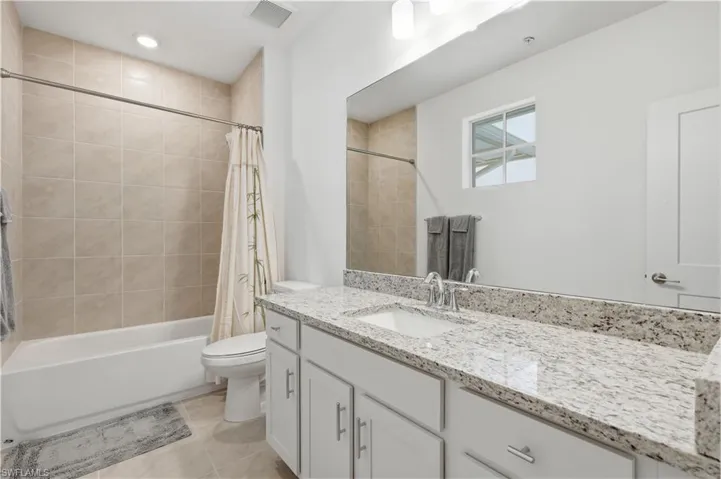 Second guest ensuite bathroom with shower/tub combo.