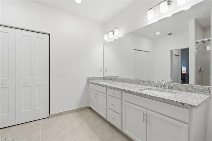 Primary bathroom with two separate sink areas, a walk-in shower and plenty of space for two!