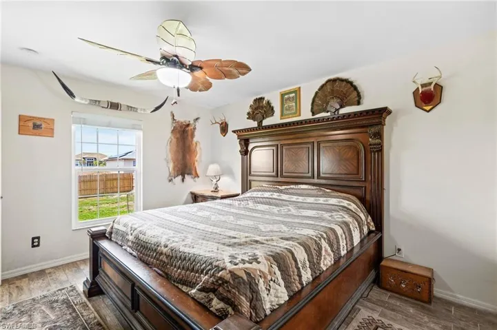 Bedroom featuring wood finished floors and a ceiling fan