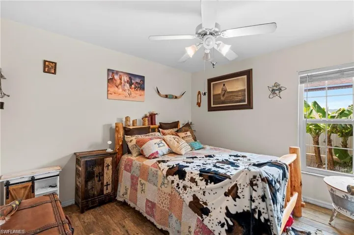 Bedroom featuring dark wood-type flooring and a ceiling fan