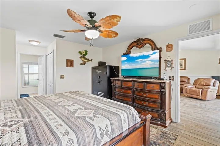 Bedroom featuring light wood-style floors, a ceiling fan, and a closet