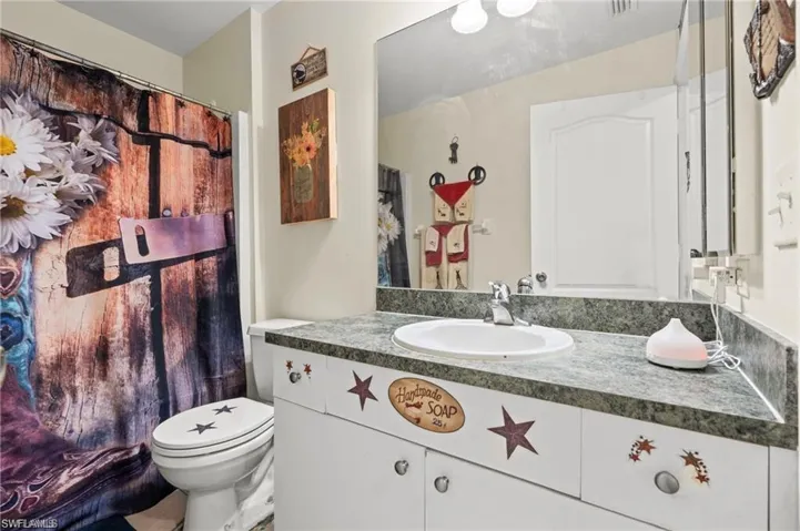 Bathroom with vanity and a shower with shower curtain