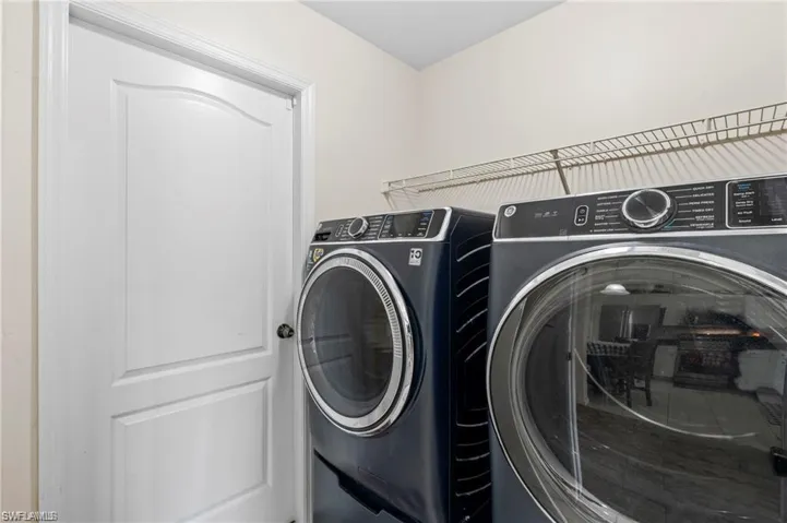 Laundry room with washer and clothes dryer