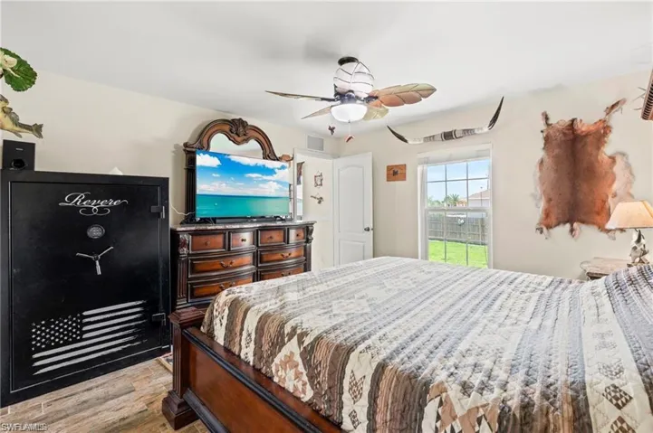 Bedroom with light wood-type flooring and a ceiling fan