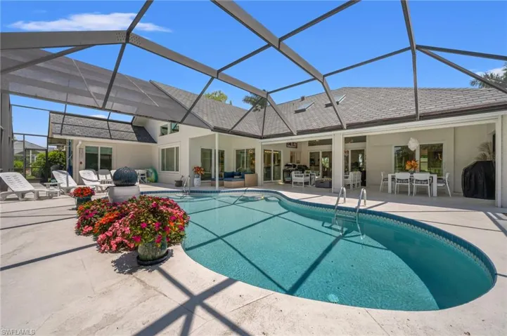 Expansive screened pool and lanai create an ideal setting for relaxed Florida living and outdoor entertaining.