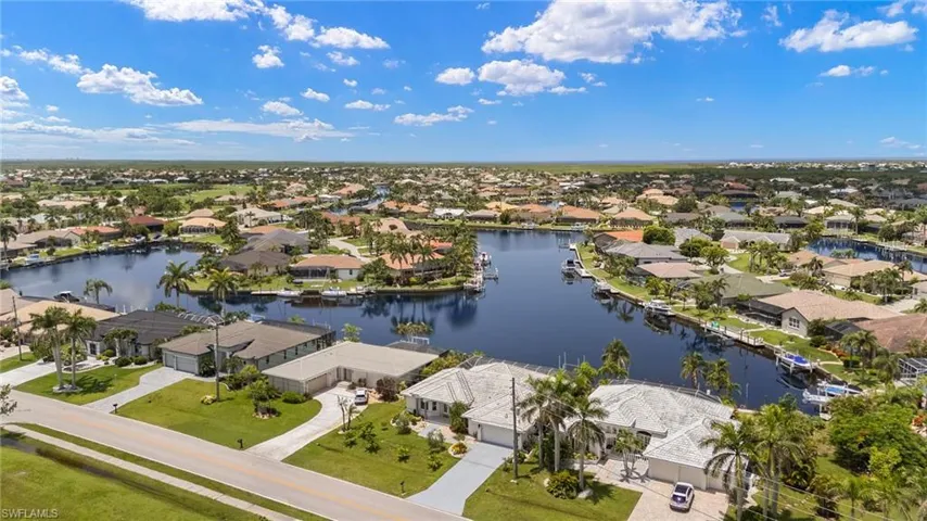 Aerial view of residential area featuring a nearby body of water
