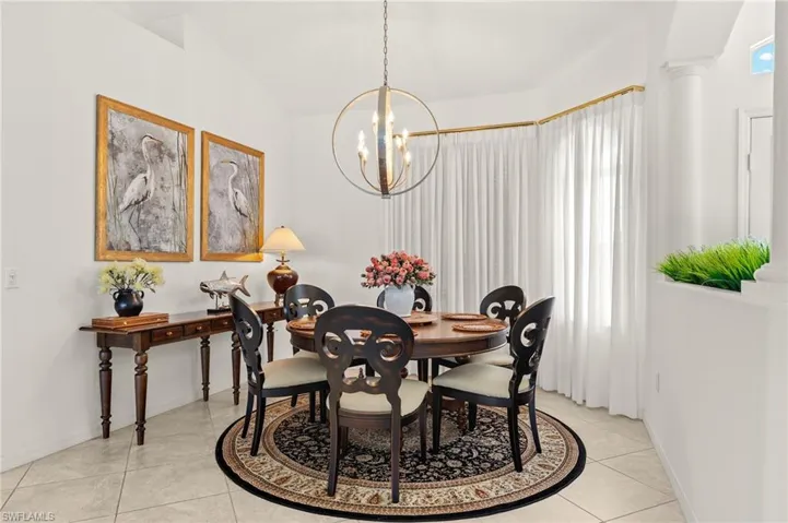 Dining space with a chandelier and light tile patterned flooring