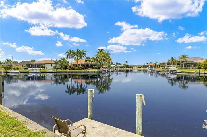 Dock area with a residential view and a water view