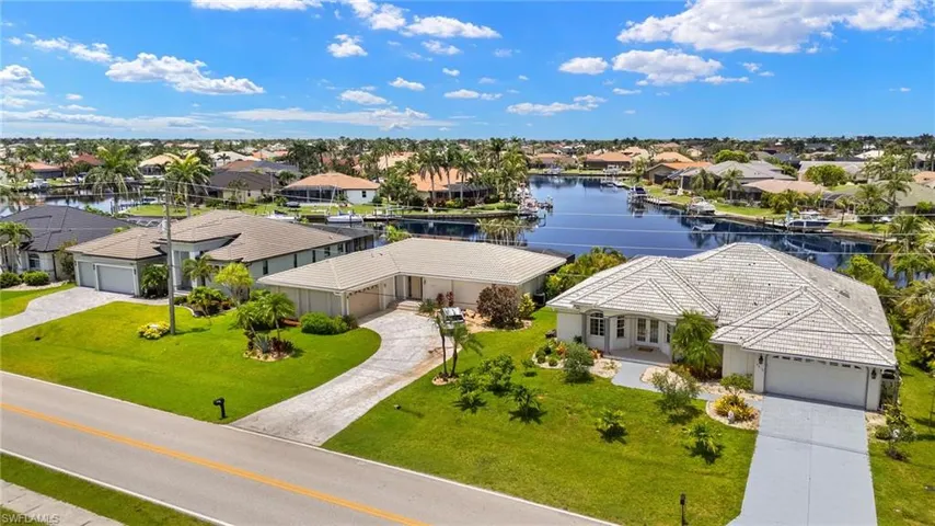 Aerial perspective of suburban area featuring a nearby body of water