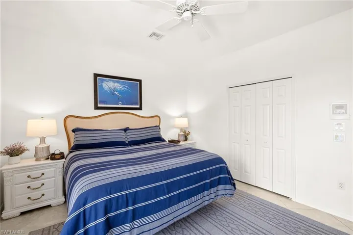 Bedroom featuring a closet, ceiling fan, and light tile patterned floors
