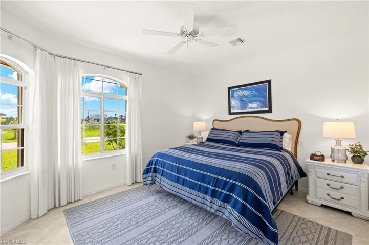 Bedroom featuring light tile patterned flooring and ceiling fan