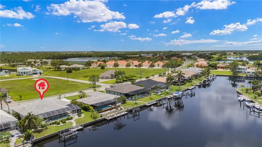 Aerial perspective of suburban area featuring a large body of water