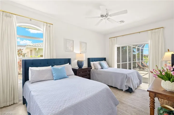 Bedroom with access to outside, ceiling fan, and light colored carpet