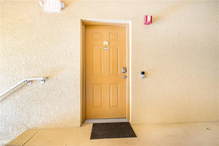 View of exterior entry with stucco siding