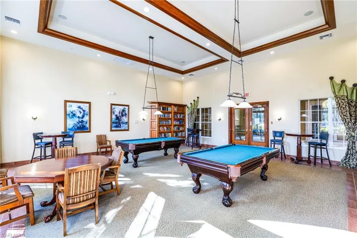 Playroom featuring a towering ceiling, billiards table, french doors, recessed lighting, and crown molding