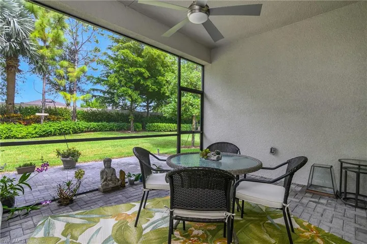 Sunroom / solarium with outdoor dining area and ceiling fan