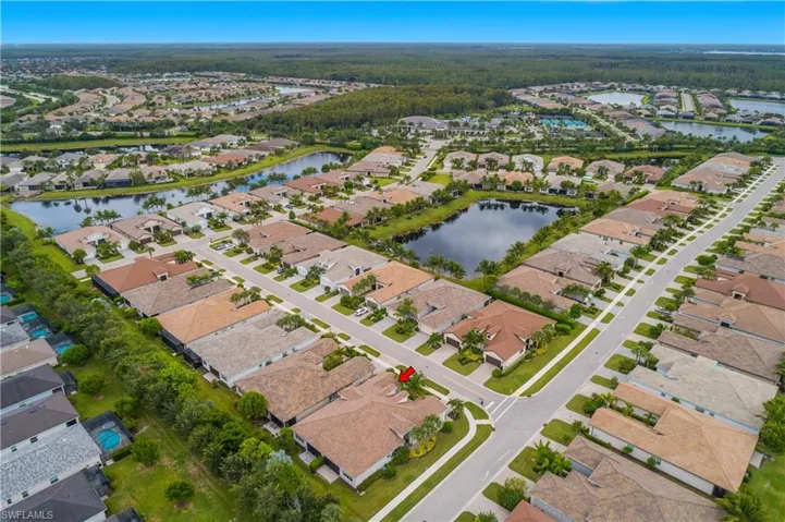 Aerial view of property and surrounding area with nearby suburban area and a nearby body of water