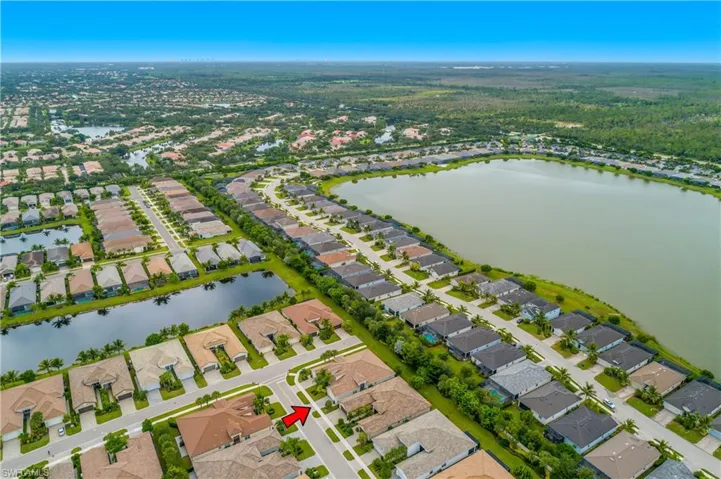 Aerial overview of property's location featuring a large body of water and nearby suburban area