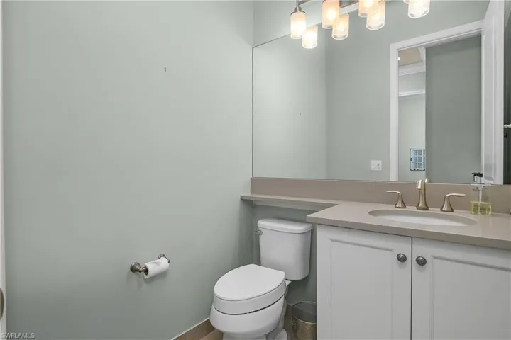 Half bathroom with vanity and toilet