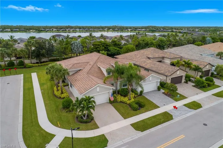 Aerial perspective of suburban area featuring a nearby body of water