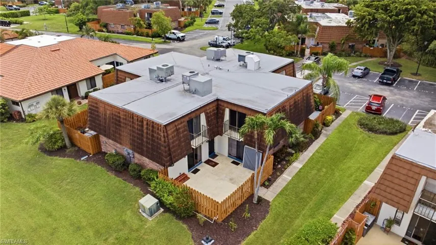 Townhome exterior featuring a flat roof and cedar shake siding