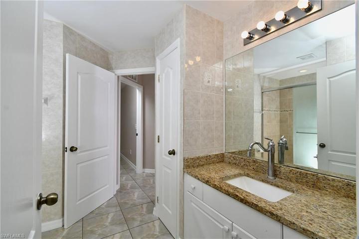 Guest bathroom. All tile walls for easy cleaning. Granite countertops.