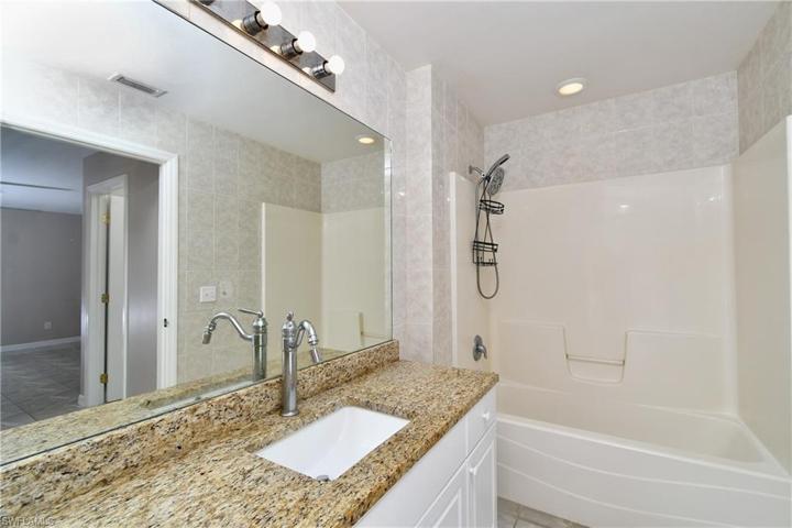 Master bathroom. Granite countertops. Tub and shower.