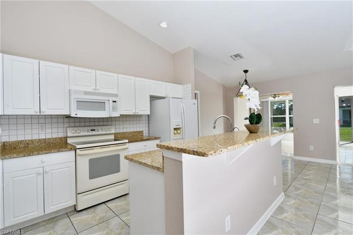 Granite countertops with large breakfast bar.