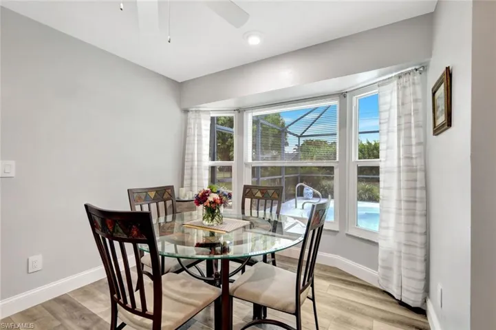 Dining space featuring ceiling fan, a wealth of natural light, and light hardwood / wood-style floors