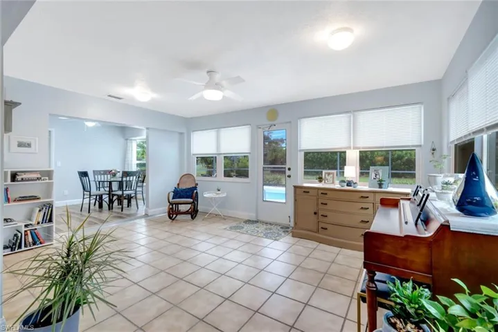 Home office with light tile patterned flooring and ceiling fan