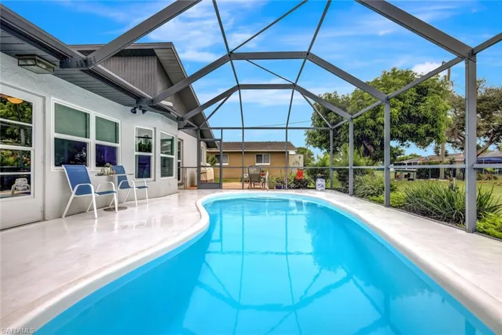 View of swimming pool featuring a lanai and a patio