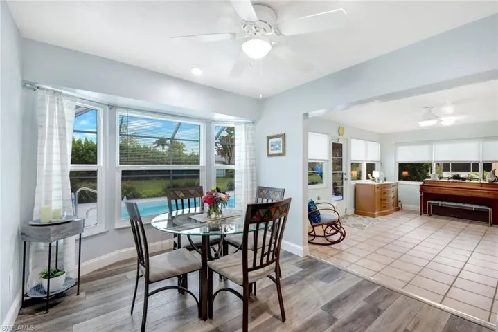Dining area with ceiling fan and light hardwood / wood-style flooring