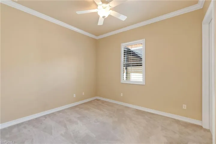 Unfurnished room featuring crown molding and light colored carpet