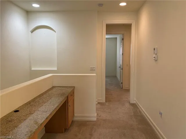 Hall with carpet, an office area, and recessed lighting