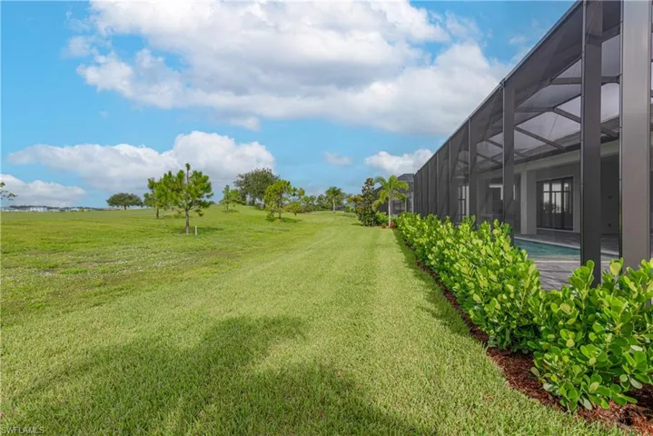 View of grassy yard featuring a lanai