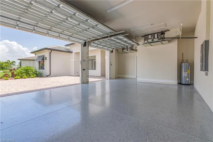 Garage with water heater and electric panel