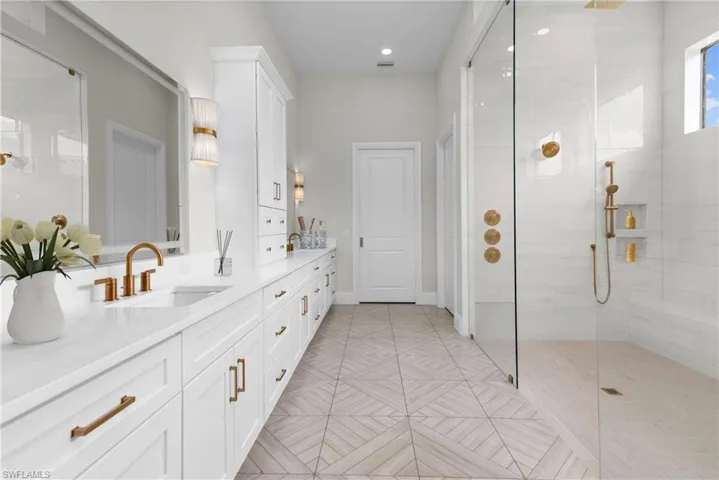 Bathroom featuring vanity and tiled shower
