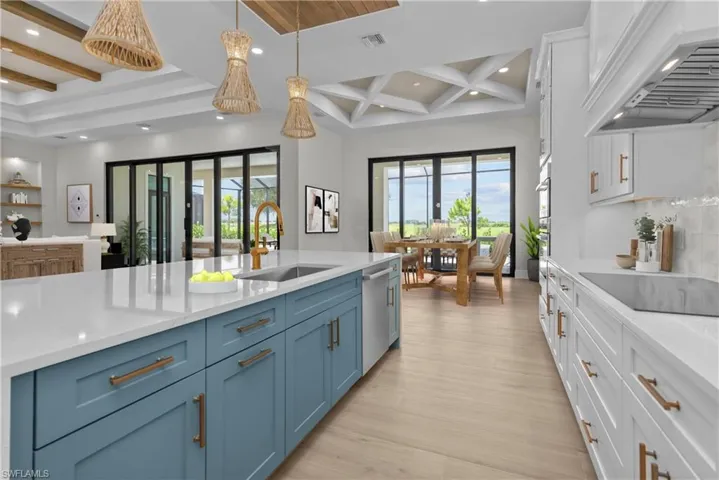 Kitchen featuring beamed ceiling, custom range hood, recessed lighting, blue cabinetry, and white cabinets