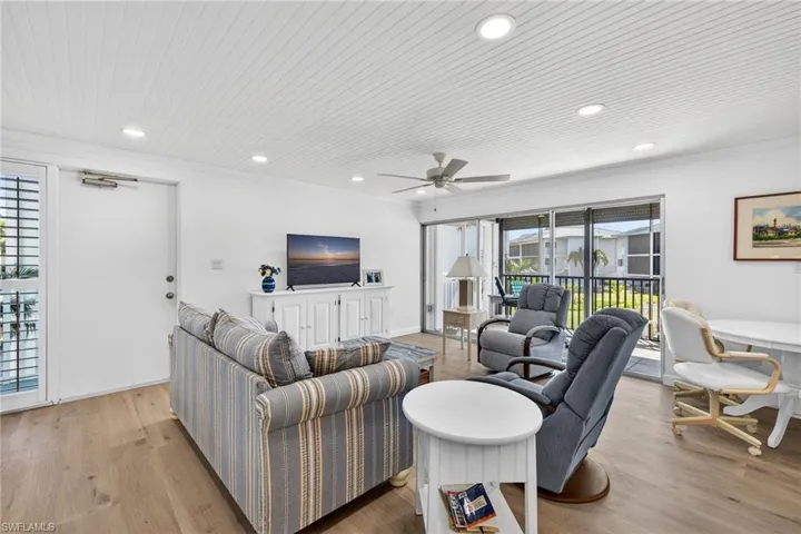 Living room featuring light wood-style flooring, a ceiling fan, wooden ceiling, recessed lighting, and crown molding