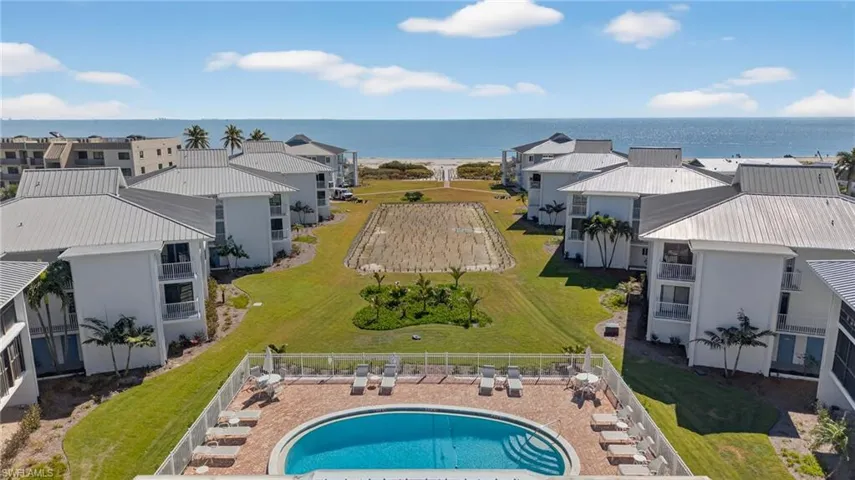 Aerial view of a nearby body of water and a pool area