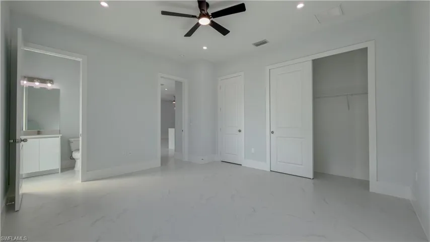 Unfurnished bedroom with recessed lighting, light marble finish flooring, and ceiling fan