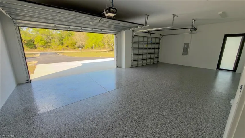 Garage with electric panel and a garage door opener
