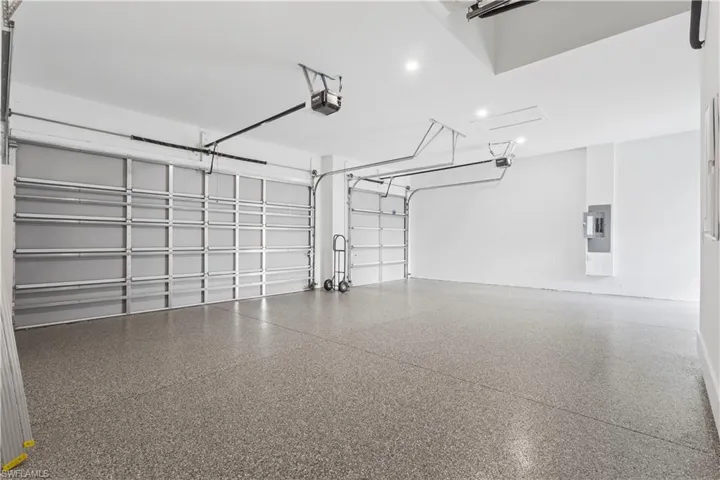 Garage featuring electric panel and a garage door opener